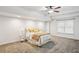Bright, carpeted bedroom with a large window and classic furnishings, offering a peaceful and comfortable atmosphere at 2656 White Rock Dr, Buford, GA 30519