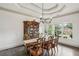 Traditional dining room with hardwood floors, coffered ceiling, large windows, and furniture at 2656 White Rock Dr, Buford, GA 30519