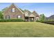 Charming brick home featuring a manicured lawn and welcoming front porch at 2656 White Rock Dr, Buford, GA 30519