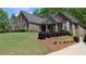 Beautiful home featuring a brick exterior with a well-manicured lawn and landscaping at 2656 White Rock Dr, Buford, GA 30519