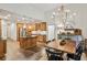 Traditional kitchen with island, wood cabinets, stainless appliances, hardwood floors, and adjacent dining area at 2656 White Rock Dr, Buford, GA 30519