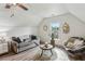 Cozy living room with vaulted ceiling, a comfortable sofa, and a round rug, creating a relaxing and inviting atmosphere at 2656 White Rock Dr, Buford, GA 30519
