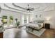Spacious main bedroom with tray ceiling, ceiling fan, hardwood floors, and access to private deck at 2656 White Rock Dr, Buford, GA 30519