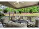 Screened porch with comfortable seating and hanging plants, offering a relaxing space to enjoy the outdoors at 2656 White Rock Dr, Buford, GA 30519