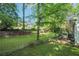 Expansive backyard featuring a stone patio and mature trees, perfect for outdoor living at 2911 Allegro Nw Dr, Atlanta, GA 30318
