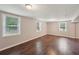 Spacious basement featuring sleek wood floors and natural light from multiple windows at 2911 Allegro Nw Dr, Atlanta, GA 30318