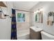 Well-lit bathroom featuring a tub, shower, vanity, toilet, and decorative mirror at 2911 Allegro Nw Dr, Atlanta, GA 30318