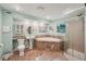 Large bathroom with tile floors, blue walls, vanity with sink, soaking tub, and a glass-enclosed shower at 2911 Allegro Nw Dr, Atlanta, GA 30318