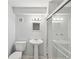 Modern bathroom featuring a glass shower, pedestal sink, and tiled walls at 2911 Allegro Nw Dr, Atlanta, GA 30318