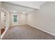 Large carpeted bedroom features neutral walls, natural lighting, and a partial view of another room at 2911 Allegro Nw Dr, Atlanta, GA 30318