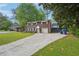 Classic two-story brick home featuring a wide driveway and bright white trim at 2911 Allegro Nw Dr, Atlanta, GA 30318