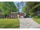 Charming brick home with a well-manicured lawn and long driveway at 2911 Allegro Nw Dr, Atlanta, GA 30318