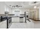Updated kitchen with stainless steel appliances, granite countertops, and white cabinetry at 2911 Allegro Nw Dr, Atlanta, GA 30318