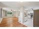 Open living space with hardwood floors, a ceiling fan, and adjacent modern kitchen at 2911 Allegro Nw Dr, Atlanta, GA 30318