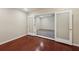 The spacious living room has neutral walls, dark hardwood floors, and a partial view of another room at 2911 Allegro Nw Dr, Atlanta, GA 30318