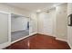 A well-lit living room with hardwood floors, an open door to another room and a white entry door at 2911 Allegro Nw Dr, Atlanta, GA 30318
