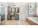 Spacious bathroom with tile floors, double sinks, vanity, soaking tub, and decorative artwork at 2930 Burnt Hickory Nw Rd, Marietta, GA 30064