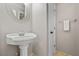 Bathroom featuring pedestal sink, decorative mirror, and chrome fixtures at 2930 Burnt Hickory Nw Rd, Marietta, GA 30064