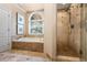 Elegant bathroom with a soaking tub, glass-enclosed shower, and luxurious finishes, offering a spa-like experience at 2930 Burnt Hickory Nw Rd, Marietta, GA 30064