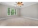 Empty bedroom with carpet flooring, neutral walls, and a large window with a natural view at 2930 Burnt Hickory Nw Rd, Marietta, GA 30064