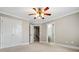 Spacious bedroom with neutral walls, crown molding, and adjacent bathroom and closet spaces at 2930 Burnt Hickory Nw Rd, Marietta, GA 30064