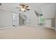 Large bonus room featuring neutral carpet, multiple doors, and a ceiling fan at 2930 Burnt Hickory Nw Rd, Marietta, GA 30064