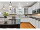 Bright kitchen with white cabinets, stainless steel appliances, hardwood floors, and a large island at 2930 Burnt Hickory Nw Rd, Marietta, GA 30064