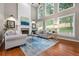 Bright living room boasts a fireplace, large windows, hardwood floors, and a beautiful blue area rug at 2930 Burnt Hickory Nw Rd, Marietta, GA 30064