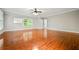 Spacious living room featuring gleaming hardwood floors, a ceiling fan, and natural light at 2930 Burnt Hickory Nw Rd, Marietta, GA 30064