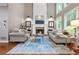Inviting living room with a brick fireplace, large windows, hardwood floors, and comfortable seating at 2930 Burnt Hickory Nw Rd, Marietta, GA 30064