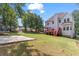 Spacious backyard featuring a wooden deck, concrete pad, and plenty of room for outdoor activities at 3113 Brians Creek Se Dr, Conyers, GA 30013
