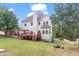 View of the home's backyard, showcasing a wooden deck and a well-maintained lawn at 3113 Brians Creek Se Dr, Conyers, GA 30013