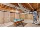 Unfinished basement with a pool table and exposed ceiling at 3113 Brians Creek Se Dr, Conyers, GA 30013