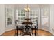Bright breakfast nook with a square table, four chairs, and natural light from surrounding windows at 3113 Brians Creek Se Dr, Conyers, GA 30013