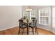 Cozy breakfast nook featuring a square table set with 4 chairs and a chandelier in front of bay windows at 3113 Brians Creek Se Dr, Conyers, GA 30013