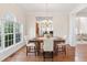 Elegant dining room featuring hardwood floors, a chandelier, and large windows with backyard views at 3113 Brians Creek Se Dr, Conyers, GA 30013