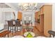 Open dining room featuring wood floors, kitchen bar access and bright light at 3113 Brians Creek Se Dr, Conyers, GA 30013
