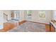 Welcoming foyer with a staircase, hardwood floors, and large windows providing plenty of natural light at 3113 Brians Creek Se Dr, Conyers, GA 30013