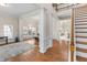 Open concept foyer showcasing hardwood floors, a staircase, and white columns defining living areas at 3113 Brians Creek Se Dr, Conyers, GA 30013