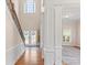 Bright entryway featuring hardwood floors, a staircase, and white columns framing the living spaces at 3113 Brians Creek Se Dr, Conyers, GA 30013