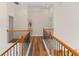 Upstairs hallway with wood floors and railings, leading to various rooms at 3113 Brians Creek Se Dr, Conyers, GA 30013