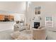 Bright living room with fireplace, plush seating, and open floor plan to kitchen and dining at 3113 Brians Creek Se Dr, Conyers, GA 30013