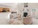 Bright living room with fireplace, plush seating, and open floor plan to kitchen and dining at 3113 Brians Creek Se Dr, Conyers, GA 30013