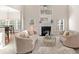 Living room with fireplace, plush sofas, open to dining area, and natural light from windows at 3113 Brians Creek Se Dr, Conyers, GA 30013