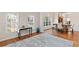Bright living area with hardwood floors, white columns, and large windows offering natural light at 3113 Brians Creek Se Dr, Conyers, GA 30013