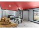 Modern living room with a unique red ceiling and natural light at 3113 Brians Creek Se Dr, Conyers, GA 30013