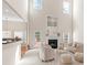 Bright and airy living room with high ceilings, a fireplace, and views of the upper-level balcony at 3113 Brians Creek Se Dr, Conyers, GA 30013