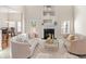 Cozy living room featuring a fireplace, modern seating, and natural light from nearby windows at 3113 Brians Creek Se Dr, Conyers, GA 30013
