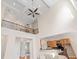 Spacious living area showcasing a soaring ceiling, open staircase, and seamless flow to the kitchen at 3113 Brians Creek Se Dr, Conyers, GA 30013
