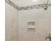 Close-up of a shower featuring stone tile, with a built-in soap holder niche at 3113 Brians Creek Se Dr, Conyers, GA 30013